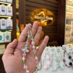 Green stone with pearl charm